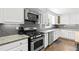 Updated kitchen with stainless steel appliances and granite countertops at 75 Auburn Rd, Auburn, GA 30011