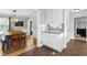 Open-concept kitchen with adjacent dining area, featuring white cabinets and modern finishes at 75 Auburn Rd, Auburn, GA 30011