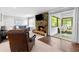 Cozy living room with a stone fireplace and sliding glass doors to an enclosed porch at 75 Auburn Rd, Auburn, GA 30011
