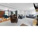 Spacious living room with a stone fireplace and access to the sunroom at 75 Auburn Rd, Auburn, GA 30011