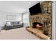 Comfortable living room with a stone fireplace and ample natural light at 75 Auburn Rd, Auburn, GA 30011