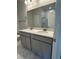 Bathroom featuring double vanity, quartz countertop, gray cabinets, and marble tile shower at 861 Pineberry Ct, Grayson, GA 30017