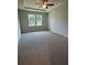 Inviting bedroom with natural light, ceiling fan, and carpeted floors, creating a comfortable retreat at 861 Pineberry Ct, Grayson, GA 30017