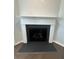 Traditional fireplace with white mantle, black surround, and hearth, adding warmth to the space at 861 Pineberry Ct, Grayson, GA 30017