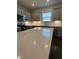Close-up of a quartz countertop kitchen island with stainless steel appliances and gray cabinetry at 861 Pineberry Ct, Grayson, GA 30017