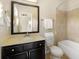Bathroom with a single sink vanity, a mirror, and a bathtub at 1365 Hawthorne Se Ave, Smyrna, GA 30080