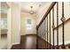 Open entryway with dark hardwood floors, a decorative railing, and a view of the front door at 1365 Hawthorne Se Ave, Smyrna, GA 30080