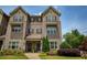 Charming brick townhome with a landscaped front yard, showcasing its inviting curb appeal and architectural details at 1365 Hawthorne Se Ave, Smyrna, GA 30080