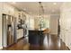 Modern kitchen with stainless steel appliances, an island with bar seating, and stylish pendant lighting at 1365 Hawthorne Se Ave, Smyrna, GA 30080