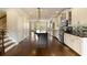 Spacious kitchen featuring a dark island, white cabinets, stainless steel appliances, hardwood floors, and an open-concept design at 1365 Hawthorne Se Ave, Smyrna, GA 30080