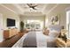 Staged main bedroom featuring a trey ceiling, hardwood floors, large windows, and neutral decor at 1365 Hawthorne Se Ave, Smyrna, GA 30080