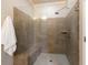 Tiled walk-in shower featuring a built-in bench and a glass enclosure at 1365 Hawthorne Se Ave, Smyrna, GA 30080