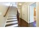 Staircase featuring hardwood steps and a railing that enhances the entryway with a classic design at 1365 Hawthorne Se Ave, Smyrna, GA 30080