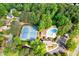 Aerial view showcasing a community pool and tennis courts nestled among lush trees and landscaping at 3543 Pine Grove Dr, Douglasville, GA 30135