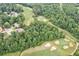 Aerial shot of a golf course surrounded by lush greenery, trees, and neighborhoods at 3543 Pine Grove Dr, Douglasville, GA 30135