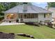 A spacious backyard featuring a patio, screened porch, and mature trees, offering a private outdoor retreat at 3543 Pine Grove Dr, Douglasville, GA 30135