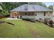 A spacious backyard featuring a patio, screened porch, and mature trees, offering a private outdoor retreat at 3543 Pine Grove Dr, Douglasville, GA 30135