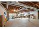 Spacious unfinished basement with exposed ceiling, work area, and garage door at 3543 Pine Grove Dr, Douglasville, GA 30135