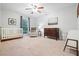 Bright bedroom with ceiling fan, carpet floors, crib, dresser and comfortable chair at 3543 Pine Grove Dr, Douglasville, GA 30135