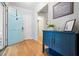 Bright foyer featuring hardwood floors, blue door, and stylish cabinet at 3543 Pine Grove Dr, Douglasville, GA 30135