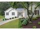 Charming home boasts a well-manicured lawn, complemented by classic black shutters and a pop of color from the front door at 3543 Pine Grove Dr, Douglasville, GA 30135