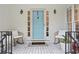 Inviting front porch with rocking chairs, a charming blue door, and stylish decor, creating a welcoming entrance at 3543 Pine Grove Dr, Douglasville, GA 30135
