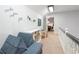 Upstairs hallway with book and art display, seating area, and natural light at 3543 Pine Grove Dr, Douglasville, GA 30135