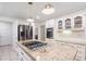 Close up of the kitchen with a granite island with a gas cooktop and stainless steel appliances at 3543 Pine Grove Dr, Douglasville, GA 30135
