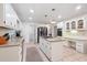Well-lit kitchen featuring a granite island with a gas cooktop and stainless steel appliances at 3543 Pine Grove Dr, Douglasville, GA 30135