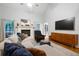 Cozy living room with a fireplace, large TV, and comfortable seating arrangement at 3543 Pine Grove Dr, Douglasville, GA 30135