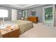 Open main bedroom featuring natural light from the windows, wood furniture, and neutral colors at 3543 Pine Grove Dr, Douglasville, GA 30135