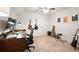 A home office with neutral colors, artwork, and guitars hanging on the wall at 3543 Pine Grove Dr, Douglasville, GA 30135