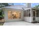 A view of the back of a home with a white patio and large windows into the dining area at 3543 Pine Grove Dr, Douglasville, GA 30135