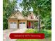 Charming two-story home featuring a two-car garage and a welcoming front porch with a vibrant red door at 36 Laurel Ne Way, White, GA 30184
