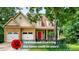 Charming two-story home featuring a combination of stone and siding, complemented by a bright red front door at 36 Laurel Ne Way, White, GA 30184