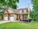 Attractive home featuring a 2-car garage, cozy front porch, and well-maintained lawn, surrounded by lush greenery at 36 Laurel Ne Way, White, GA 30184