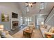 Bright living room features high ceilings, fireplace with stone surround, and hardwood flooring at 36 Laurel Ne Way, White, GA 30184