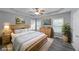 Spacious bedroom with tray ceiling, neutral paint, large window, and beautiful hardwood floors at 36 Laurel Ne Way, White, GA 30184