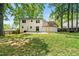 Spacious backyard with lush lawn, patio, and privacy fence, perfect for outdoor living at 385 Russell Ridge Dr, Lawrenceville, GA 30043