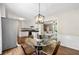 Open-concept kitchen and dining area with stainless steel appliances and hardwood floors at 385 Russell Ridge Dr, Lawrenceville, GA 30043