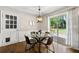 Cozy dining area with backyard access, hardwood floors, and space for four at 385 Russell Ridge Dr, Lawrenceville, GA 30043
