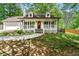 Charming home boasts a welcoming front porch, white siding, and a well-manicured front yard at 385 Russell Ridge Dr, Lawrenceville, GA 30043