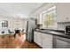 Clean kitchen equipped with stainless steel appliances, dark counters, and natural light from a window at 385 Russell Ridge Dr, Lawrenceville, GA 30043