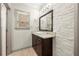Stylish bathroom features a modern vanity, decorative mirror and accent wall at 4015 Roberts Crest Ln, Suwanee, GA 30024