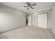 Inviting bedroom features neutral tones, plush carpet, ceiling fan, and natural light creating a comfortable space at 4015 Roberts Crest Ln, Suwanee, GA 30024