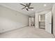 Bright bedroom features a ceiling fan, neutral paint, and an organized closet space at 4015 Roberts Crest Ln, Suwanee, GA 30024