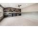 Spacious bonus room with an accent wood wall, built-in cabinets and shelving and soft carpet at 4015 Roberts Crest Ln, Suwanee, GA 30024