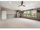 Large bonus room with carpet, paneled walls, accent wood wall, and a ceiling fan at 4015 Roberts Crest Ln, Suwanee, GA 30024