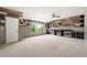 Large bonus room with carpet, paneled walls, accent wood wall, built-in cabinets, and a ceiling fan at 4015 Roberts Crest Ln, Suwanee, GA 30024