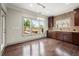 The dining room features hardwood floors, modern lighting, and natural light from large windows at 4015 Roberts Crest Ln, Suwanee, GA 30024